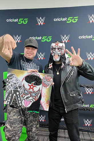 WWE Superstar with fan holding a poster of the WWE Superstar